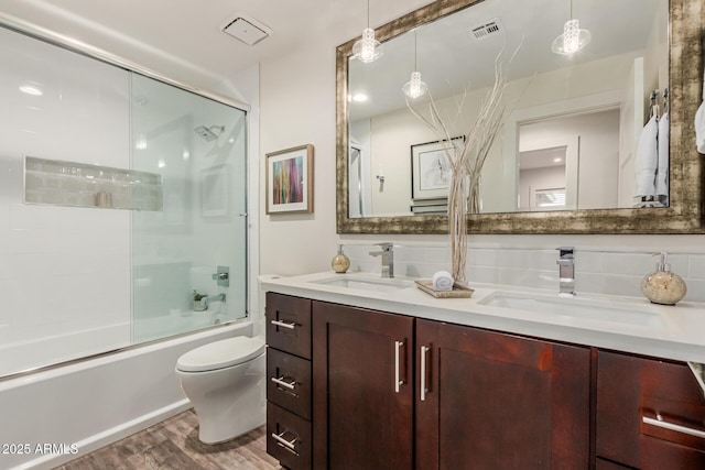 11822 S Coconino St, Phoenix, AZ 85044 - full bath featuring wood finished floors, bath / shower combo with glass door, toilet, and double vanity