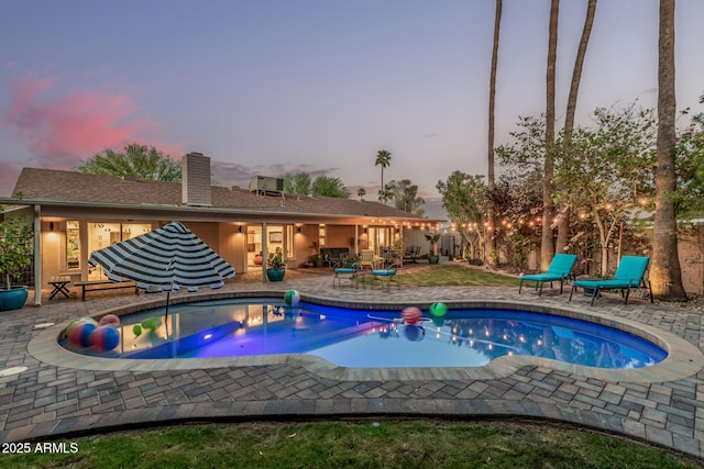 11822 S Coconino St, Phoenix, AZ 85044 - pool at dusk featuring an outdoor pool and a patio