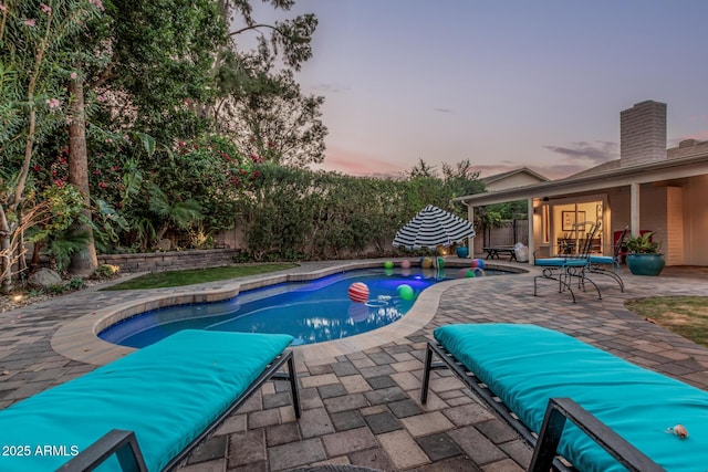 11822 S Coconino St, Phoenix, AZ 85044 - pool at dusk featuring a patio area and a fenced backyard