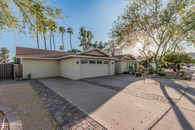 11822 S Coconino St, Phoenix, AZ 85044 - ranch-style home with a garage, brick siding, and driveway