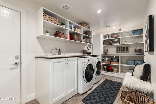 11822 S Coconino St, Phoenix, AZ 85044 - laundry area featuring washing machine and clothes dryer, cabinet space, light wood finished floors, and recessed lighting