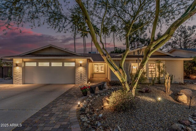 11822 S Coconino St, Phoenix, AZ 85044 - view of front facade with driveway, a garage, and brick siding