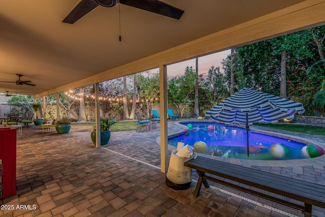 11822 S Coconino St, Phoenix, AZ 85044 - pool at dusk featuring a ceiling fan, a patio, and a fenced backyard