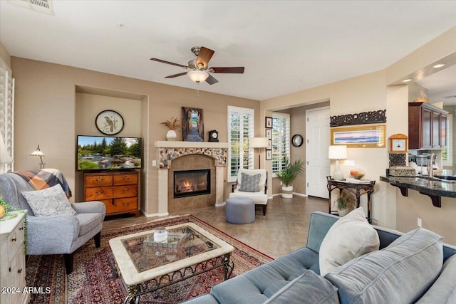 living room with ceiling fan and sink