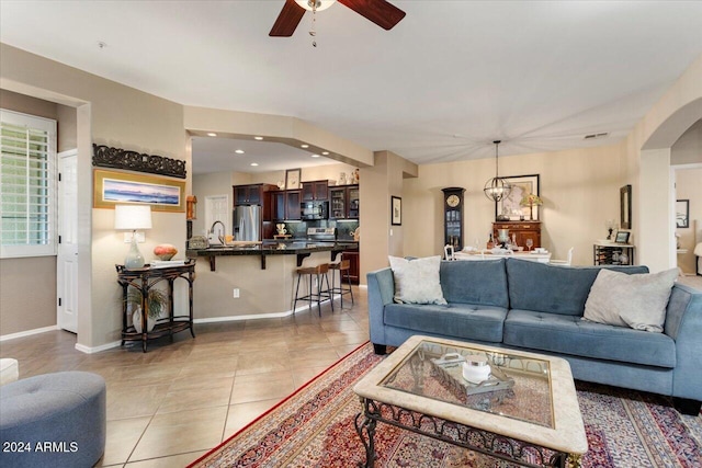 living room featuring ceiling fan and light tile patterned flooring