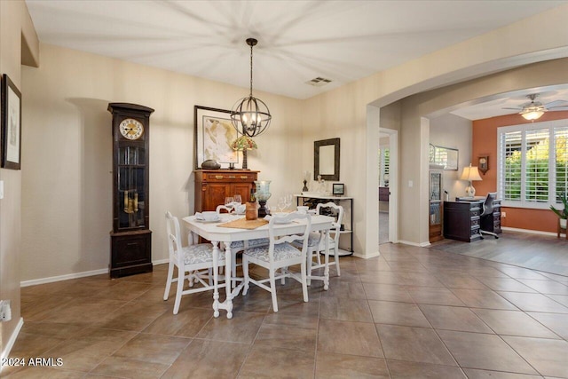 dining room with ceiling fan with notable chandelier and hardwood / wood-style flooring