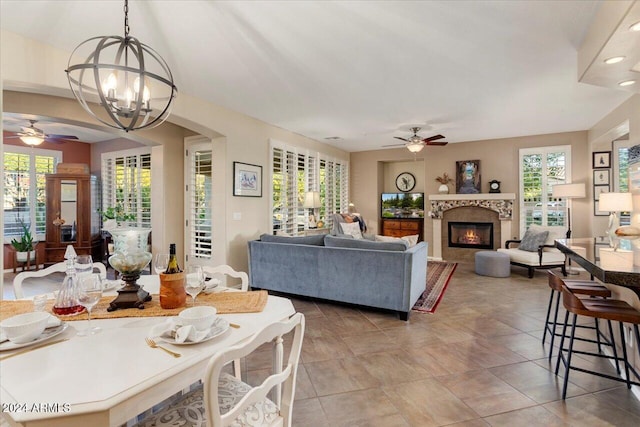 living room with ceiling fan with notable chandelier