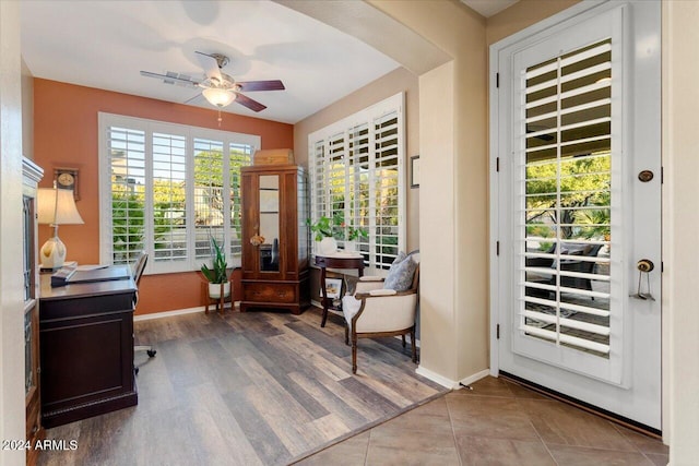 doorway to outside with hardwood / wood-style floors and ceiling fan