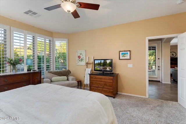 carpeted bedroom with ceiling fan and access to outside