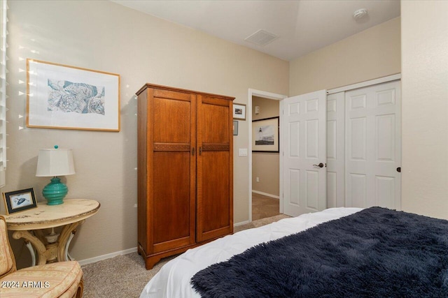 bedroom with a closet and light colored carpet