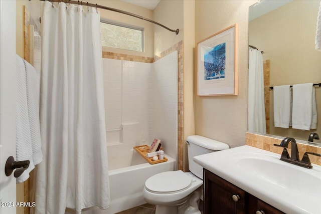 full bathroom with shower / tub combo with curtain, vanity, and toilet