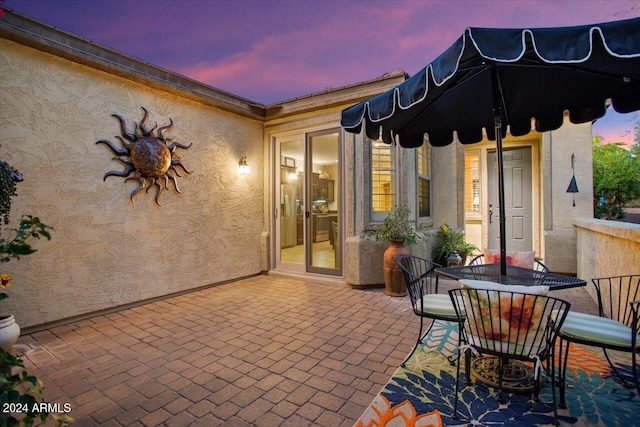 view of patio terrace at dusk