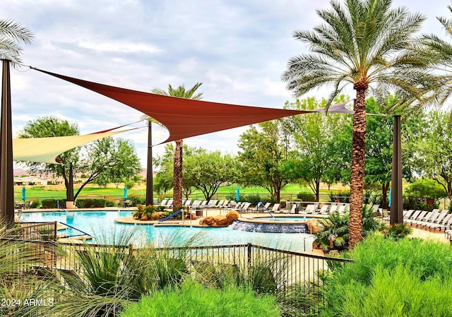 view of swimming pool with a jacuzzi