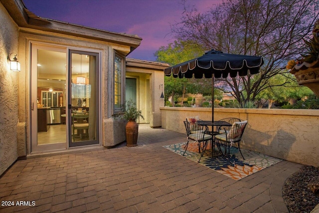 view of patio terrace at dusk