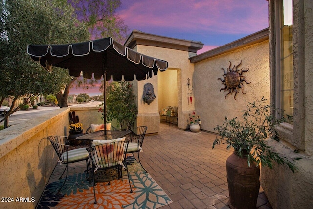 view of patio terrace at dusk