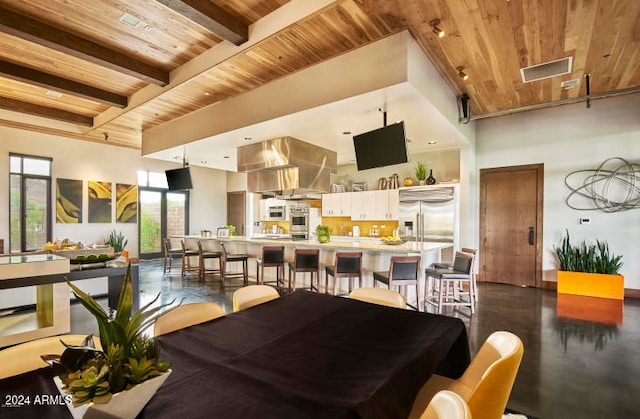 dining room featuring beam ceiling and wood ceiling