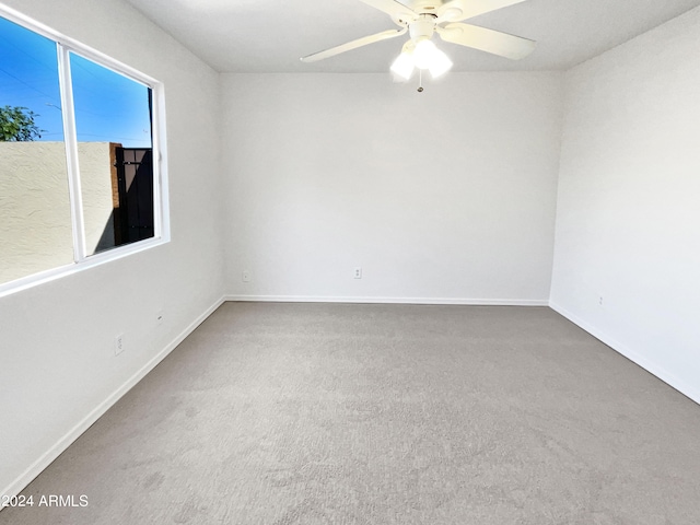 spare room with ceiling fan and carpet floors