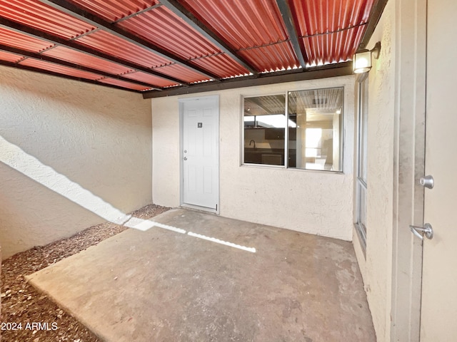 view of exterior entry featuring a patio area