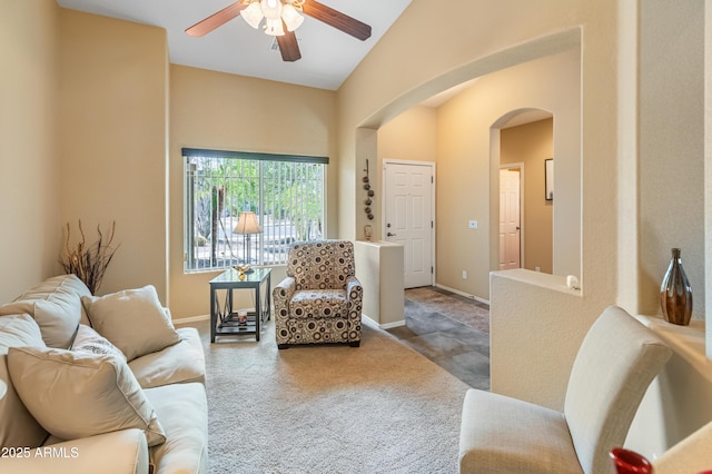 44574 W High Desert Trl, Maricopa, AZ 85139 - carpeted living room with arched walkways, a ceiling fan, vaulted ceiling, and baseboards