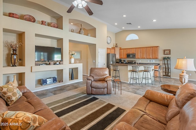 44574 W High Desert Trl, Maricopa, AZ 85139 - living area with high vaulted ceiling, built in features, recessed lighting, baseboards, and a ceiling fan
