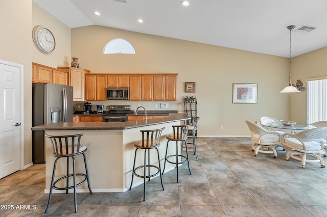 44574 W High Desert Trl, Maricopa, AZ 85139 - kitchen featuring visible vents, appliances with stainless steel finishes, a healthy amount of sunlight, and high vaulted ceiling