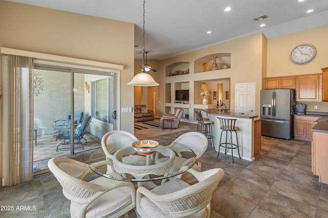 44574 W High Desert Trl, Maricopa, AZ 85139 - dining area featuring visible vents, recessed lighting, a towering ceiling, and built in shelves