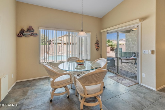 44574 W High Desert Trl, Maricopa, AZ 85139 - dining space featuring baseboards and lofted ceiling