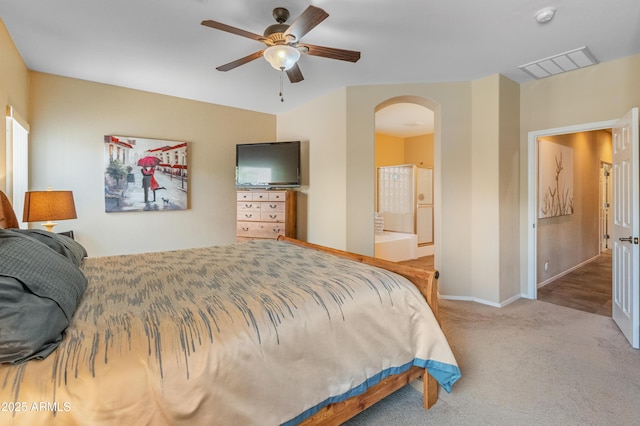44574 W High Desert Trl, Maricopa, AZ 85139 - carpeted bedroom with ceiling fan, visible vents, arched walkways, baseboards, and ensuite bath