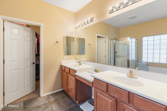 44574 W High Desert Trl, Maricopa, AZ 85139 - bathroom featuring double vanity, a spacious closet, a shower stall, and a sink