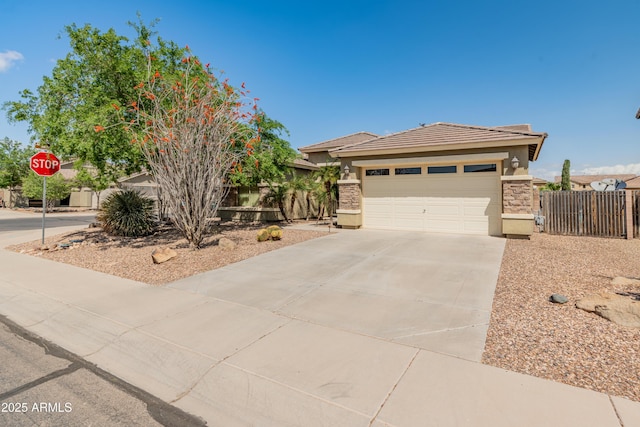 44574 W High Desert Trl, Maricopa, AZ 85139 - view of front of property featuring fence, a tile roof, stone siding, stucco siding, and driveway