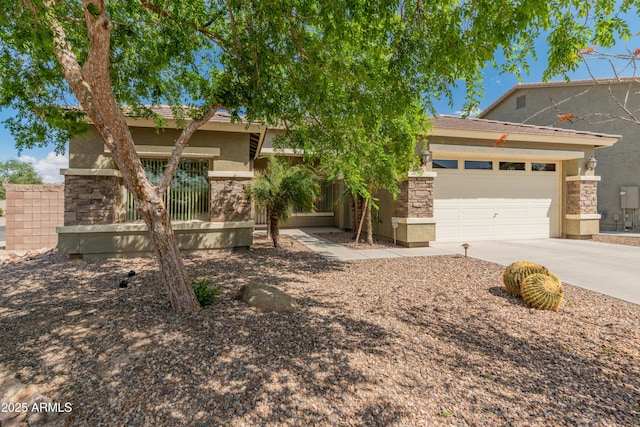 44574 W High Desert Trl, Maricopa, AZ 85139 - view of property hidden behind natural elements featuring an attached garage, concrete driveway, stucco siding, and stone siding