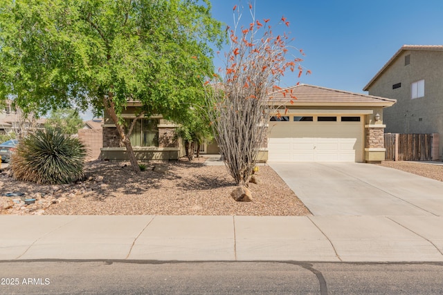 44574 W High Desert Trl, Maricopa, AZ 85139 - view of front facade with fence, an attached garage, a tile roof, stucco siding, and concrete driveway