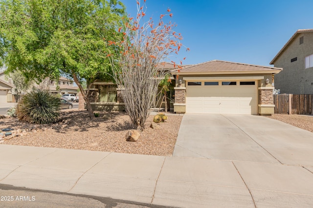 44574 W High Desert Trl, Maricopa, AZ 85139 - view of front facade featuring stone siding, stucco siding, concrete driveway, an attached garage, and a tile roof