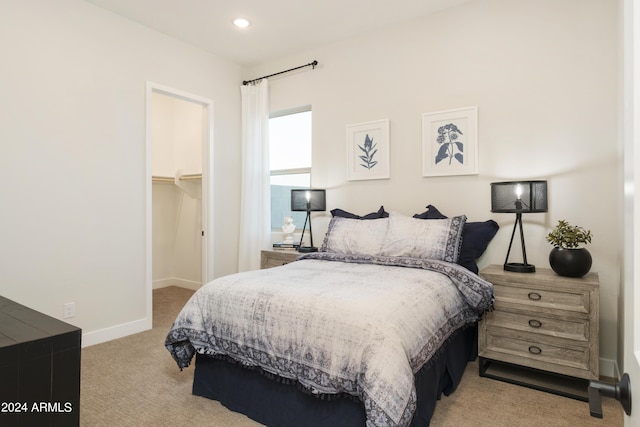 bedroom featuring a walk in closet, recessed lighting, a closet, carpet floors, and baseboards