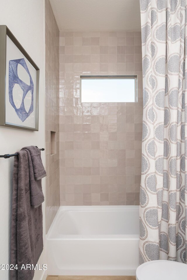 full bath featuring shower / tub combo with curtain