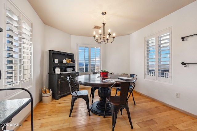 dining area featuring a chandelier and light hardwood / wood-style flooring