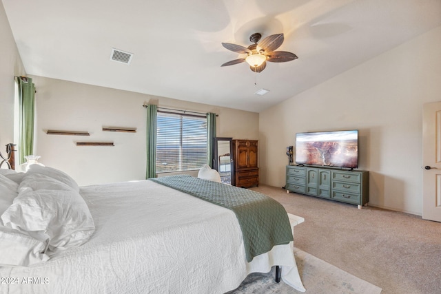 bedroom with ceiling fan, light carpet, and vaulted ceiling