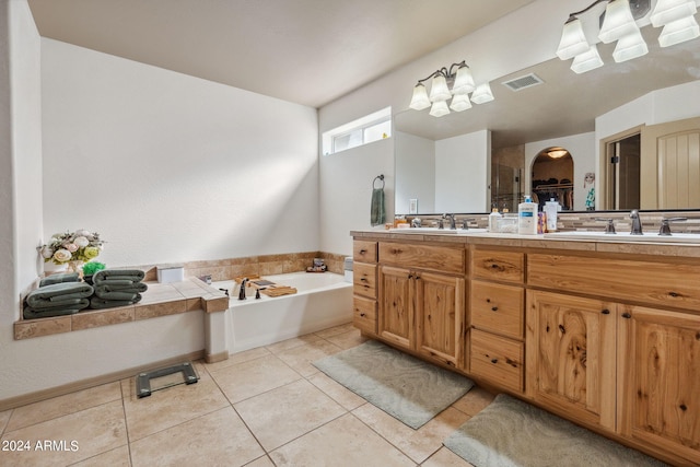 bathroom with vanity, a tub to relax in, and tile patterned flooring