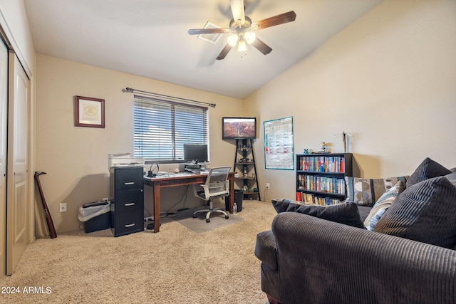 office area featuring vaulted ceiling, light colored carpet, and ceiling fan