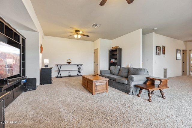 carpeted living room with ceiling fan