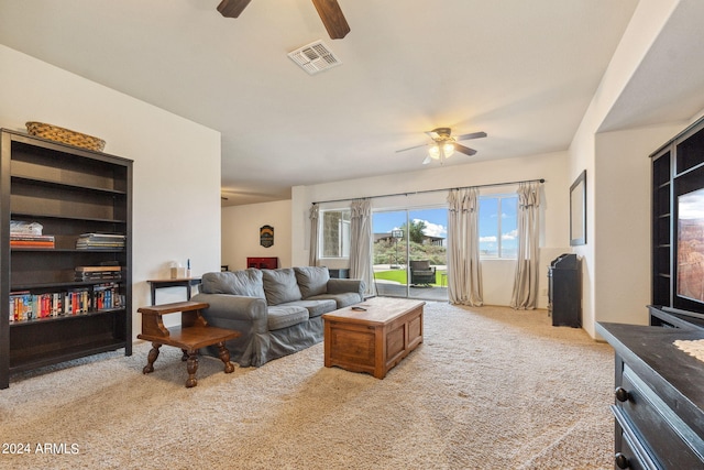 living room featuring light colored carpet and ceiling fan