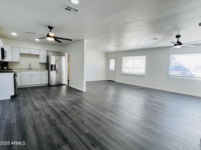 kitchen featuring white cabinetry, sink, stainless steel fridge with ice dispenser, dark hardwood / wood-style flooring, and white range