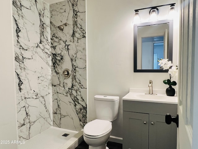 bathroom with vanity, toilet, and walk in shower