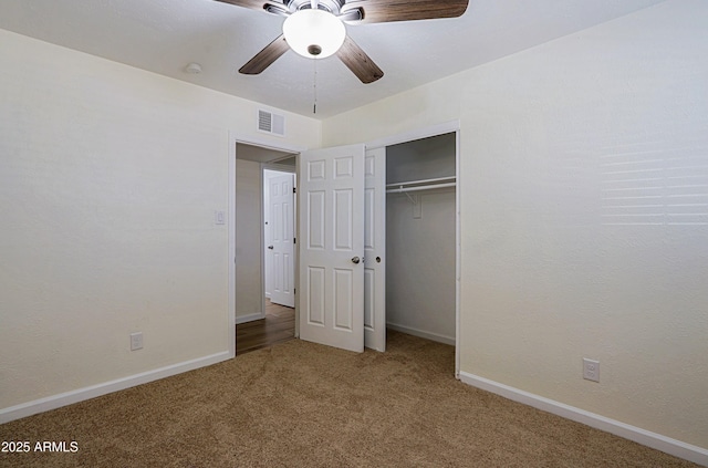 unfurnished bedroom featuring ceiling fan, carpet, and a closet