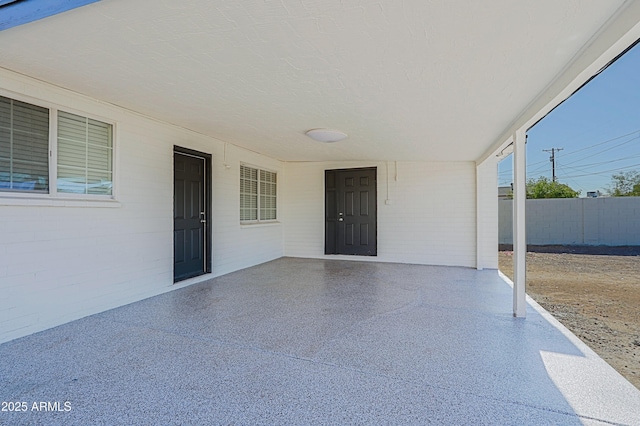 entrance to property featuring a patio area