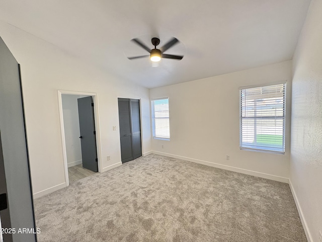 6419 W Monte Cristo Ave, Glendale, AZ 85306 - unfurnished bedroom featuring vaulted ceiling, light carpet, baseboards, and a ceiling fan