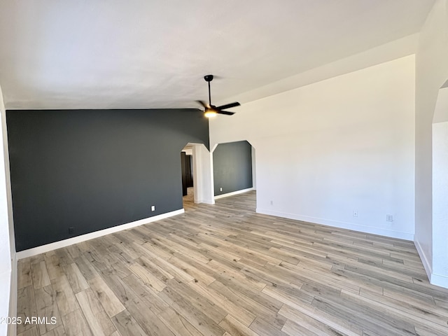 6419 W Monte Cristo Ave, Glendale, AZ 85306 - spare room featuring arched walkways, ceiling fan, light wood-style floors, baseboards, and lofted ceiling