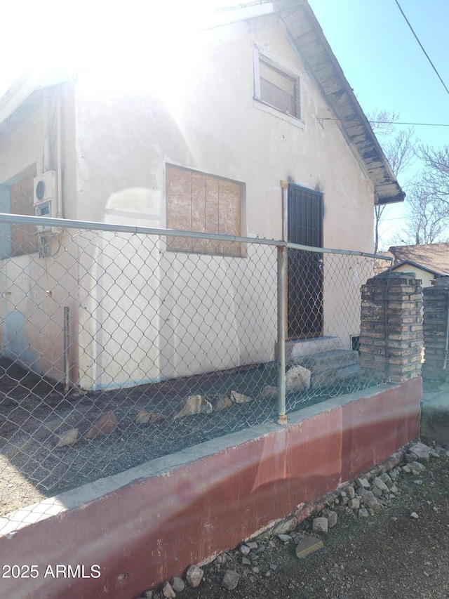 exterior space with fence and stucco siding