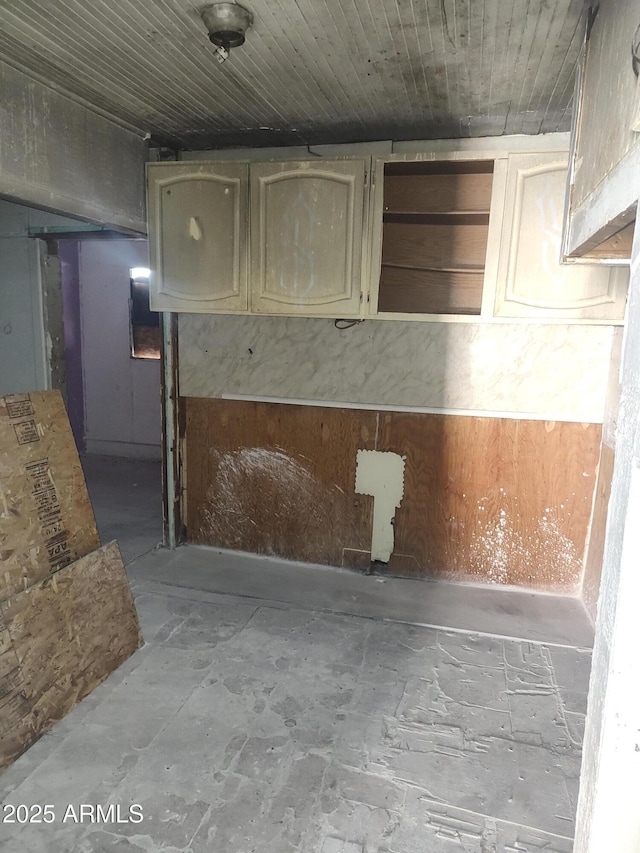 interior space with open shelves and cream cabinets