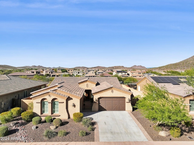 view of front facade featuring a mountain view and a garage